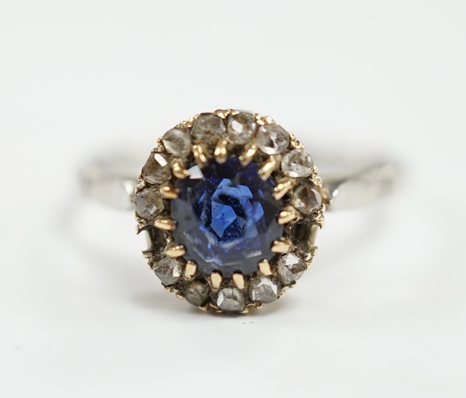 An early 20th century white metal (stamped plat), sapphire and diamond set cluster ring, size O, gross weight 3.6 grams. Condition - poor (two stones missing)